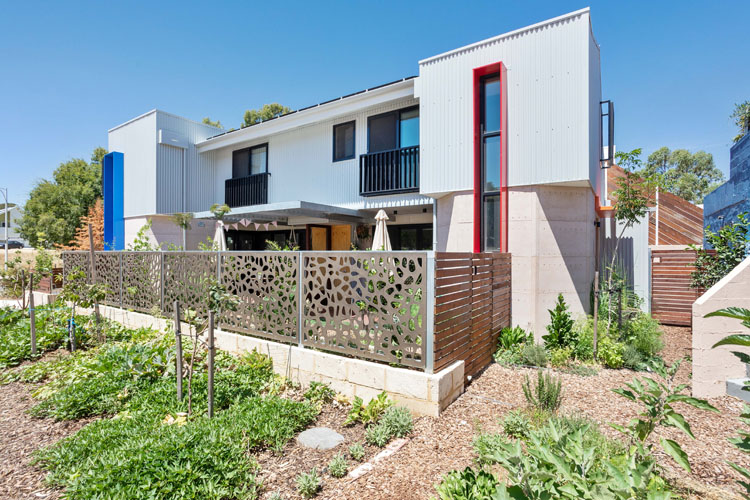 A pair of modern apartments with a productive front garden. 