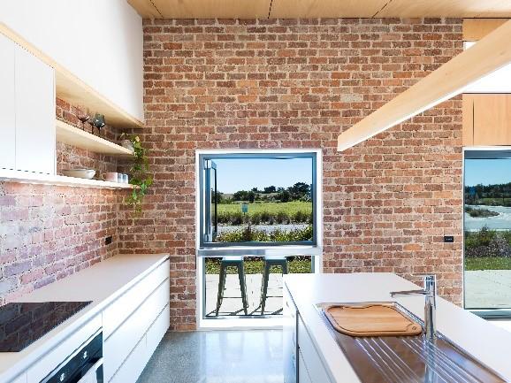 An exposed brick wall in the kitchen helps regulate internal temperatures.